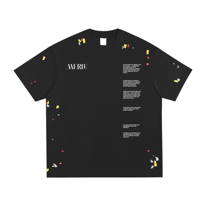 Black t-shirt with colorful small designs and text on a white background